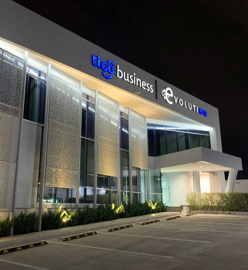 millicom-hero Image of Milicom building at night from the parking lot.